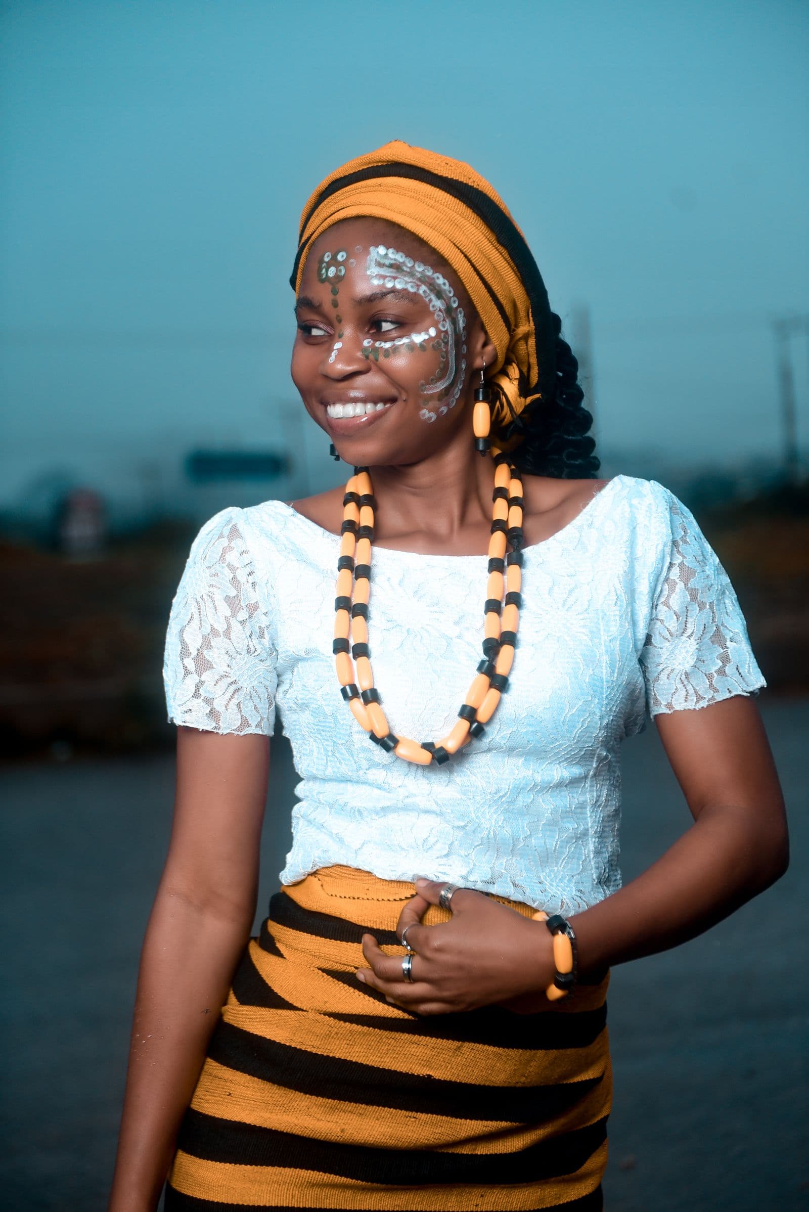 Smiling African woman in traditional attire radiating joy