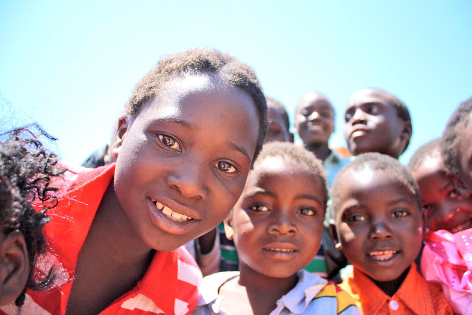 Happy African children under a bright open sky